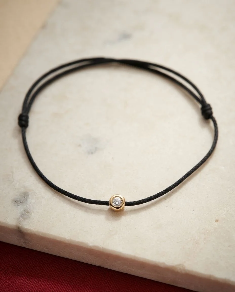 Armband Zarge 18 Karat Gelbgold, schwarzes cord 15,5-19,5cm · drapiert