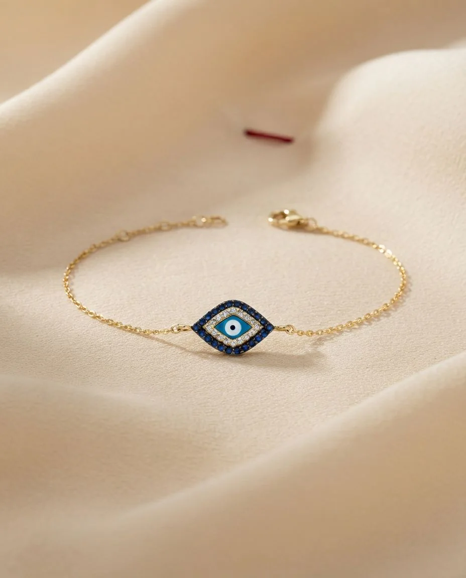 Armband 18 Karat Gelbgold Auge, Fassung schwarz rhodiniert · drapiert