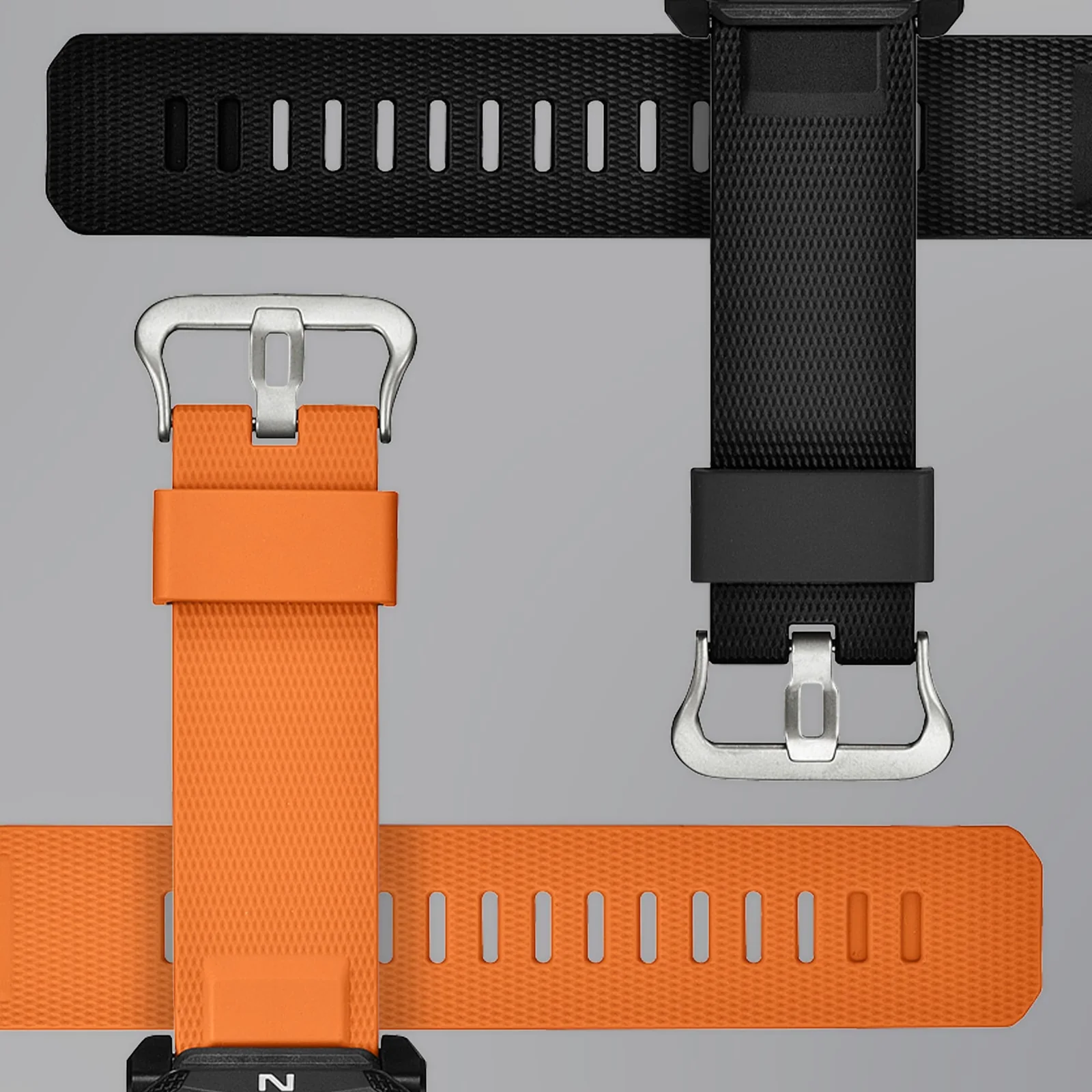 Das orangene Armband der PRG-69-4ER und das schwarze Armband der PRG-69-1ER liegen gekreuzt untereinander